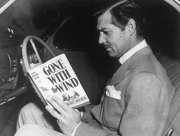 He is reading 